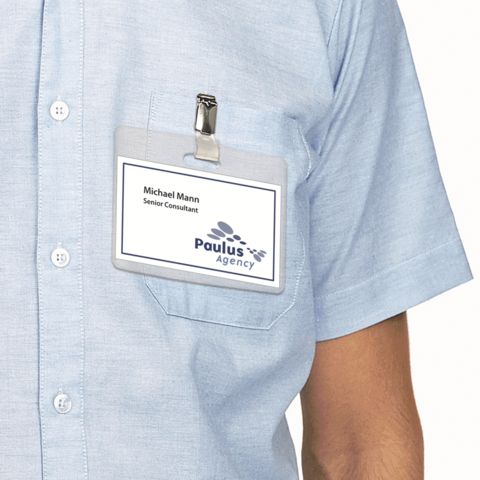 Namensschild mit der Aufschrift "Michael Mann, Senior Consultant" und dem Logo der Paulus Agency auf einem blauen Hemd.