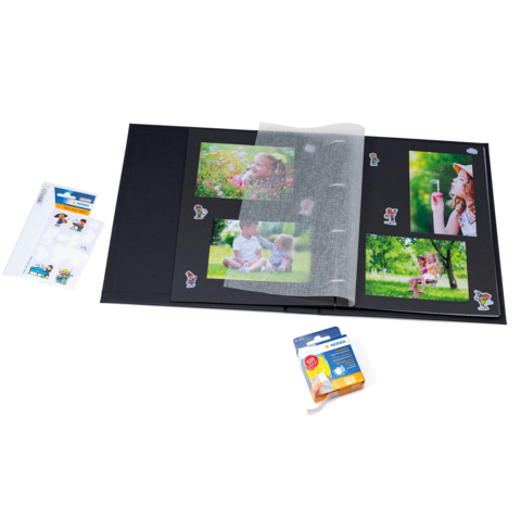 Ein Fotoalbum mit mehreren Bildern, einer transparenten Schutzfolie, Aufklebern und einer Packung Fotokleber.