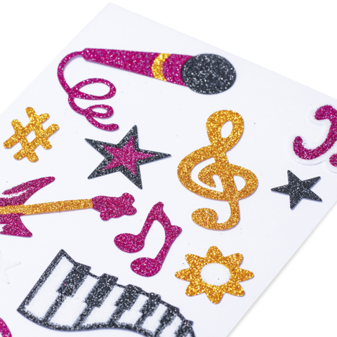Bunte Aufkleber mit Musikmotiven, darunter ein Mikrofon, Noten, ein Klavier und Sterne in verschiedenen Farben.